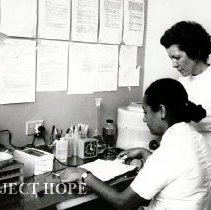 Mary Lou Ahearn, Medical Technologist, with counterpart in lab